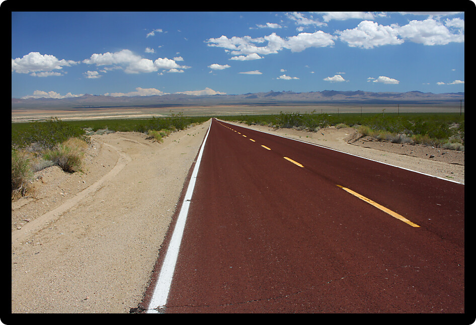 Long road runs through the vast openness of the Mojave National Preserve in California.