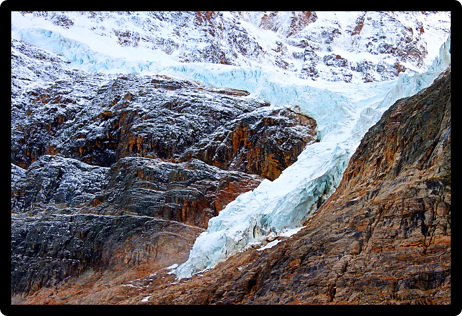 Angel Glacier hangs over a cliff below Mount Edith Cavell in Jasper National Park Canada.