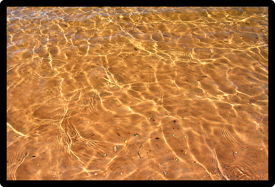 Interesting patterns in the sand seen through crystal clear Wisconsin waters.
