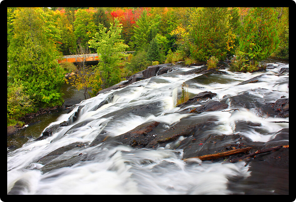 Autumn foliage surrounds the cascading waters of Bond Falls in northern Michigan.