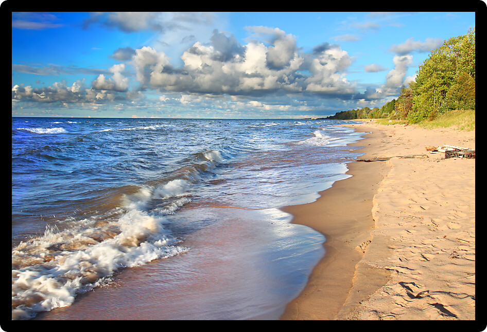 Waves along the beach of Lake Superior in northern Michigan under beautiful sunlight.