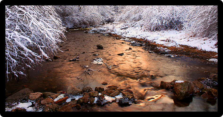 Willow Creek flows through Rock Cut State Park of Illinois on a snowy winter day.