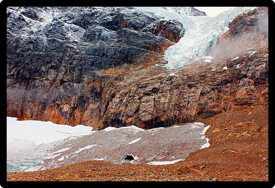 Angel Glacier hangs over a cliff below Mount Edith Cavell in Jasper National Park Canada.