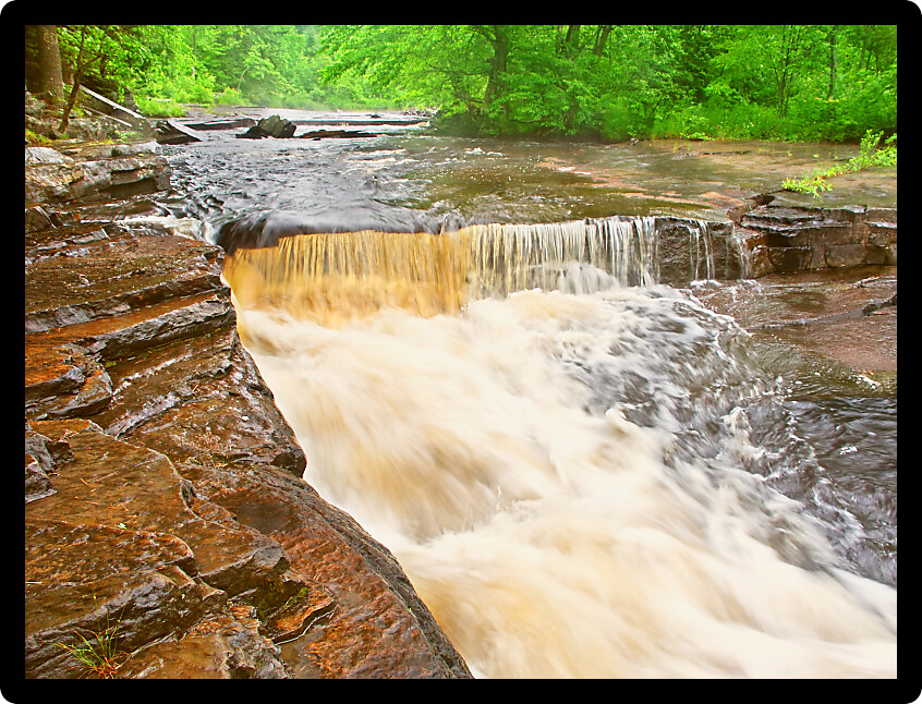 Canyon Falls flowing through the forests of Baraga County Michigan.