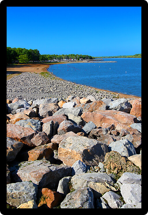 Rocky southern shoreline and swimming beach of Carlyle Lake in Illinois.