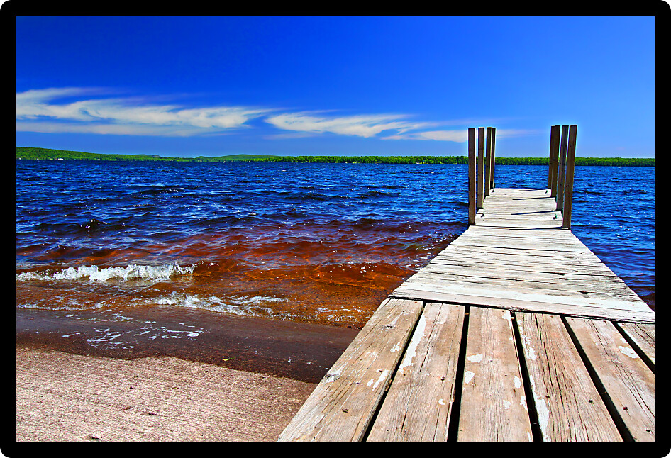 Wooden dock and choppy waters of Lake Gogebic at Ontonagon County Park Michigan.