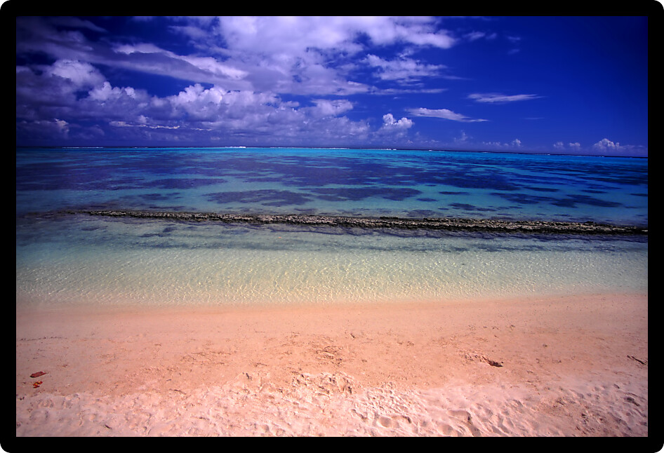 Sandy beach and crystal clear lagoon on the island of Moorea French Polynesia.