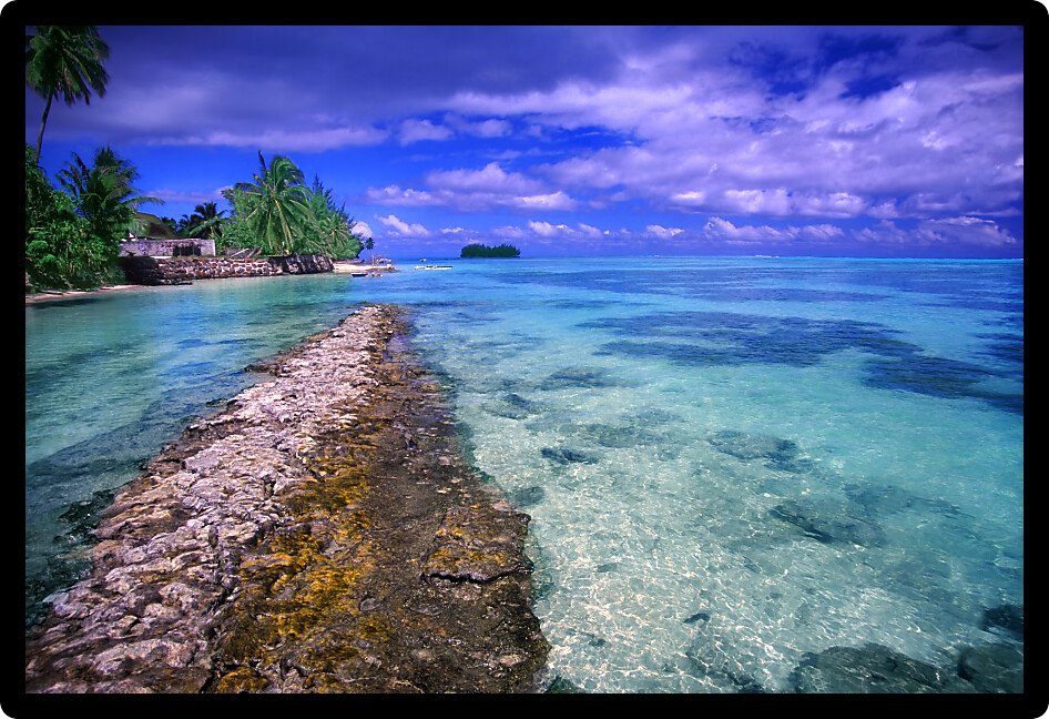 Sandy beach and crystal clear lagoon on the island of Moorea French Polynesia.