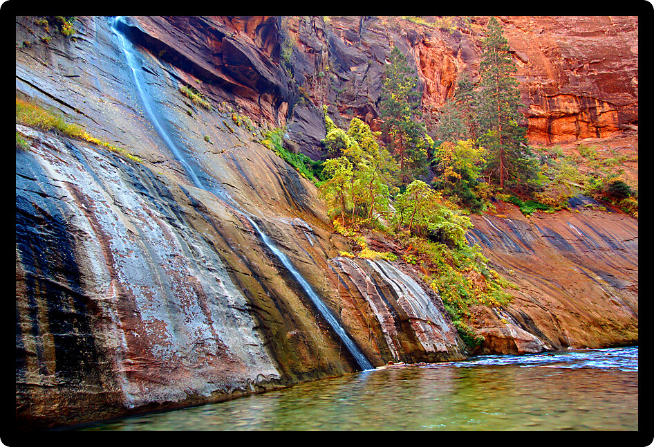 Mystery Falls flows into Virgin River Narrows in Zion National Park Utah.