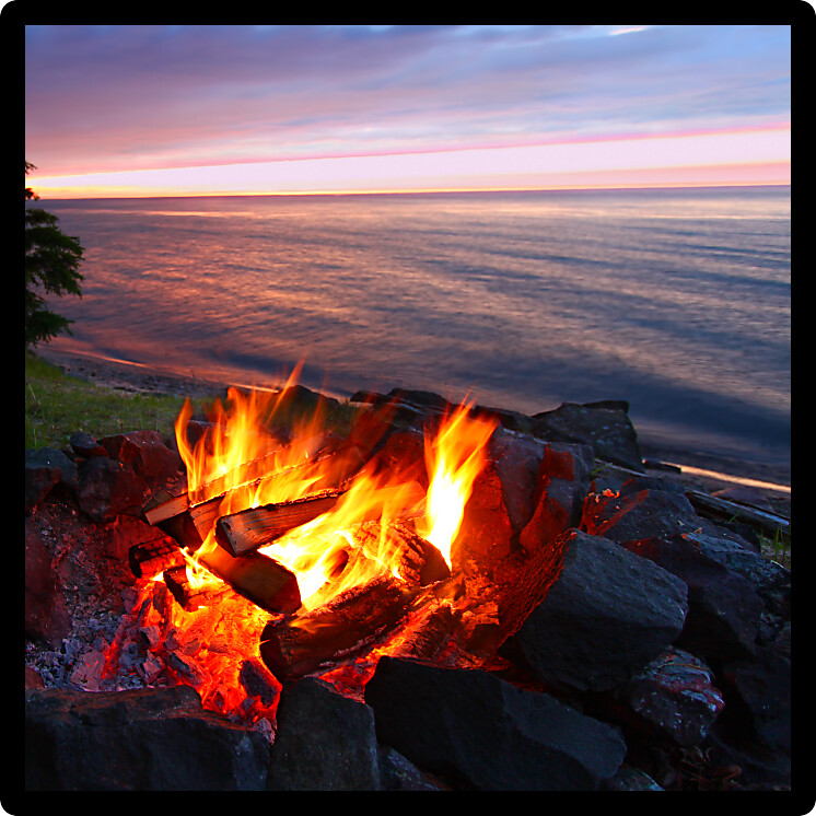 Sunset camp fire along the beautiful beach of Lake Superior in northern Michigan.