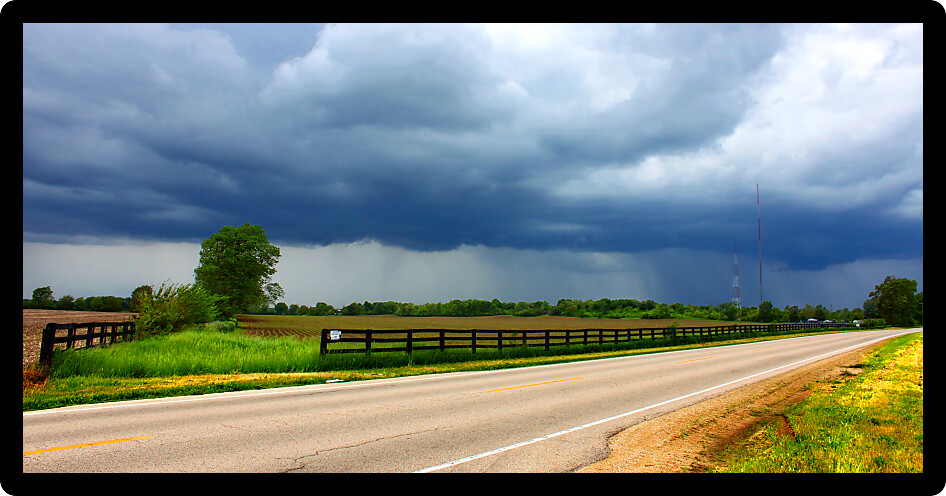 Heavy spring rains sweep over agricultural fields outside the village of Cherry Valley Illinois.