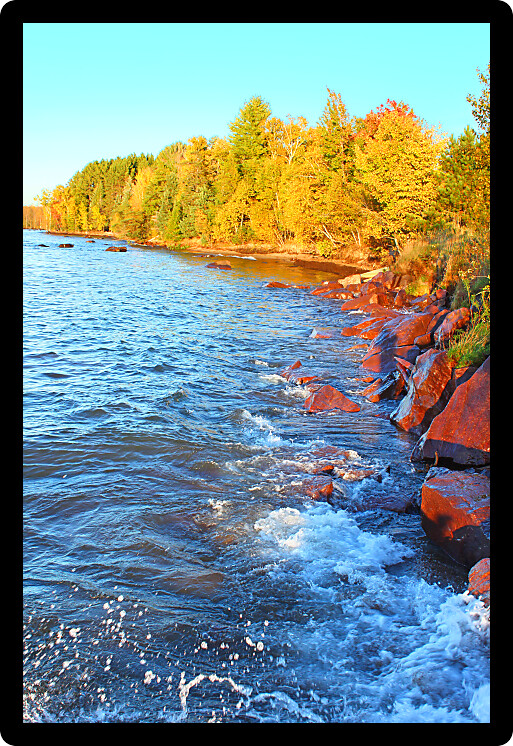 Waves crash along a rocky shoreline of Lake Superior in Ontonagon County Michigan.