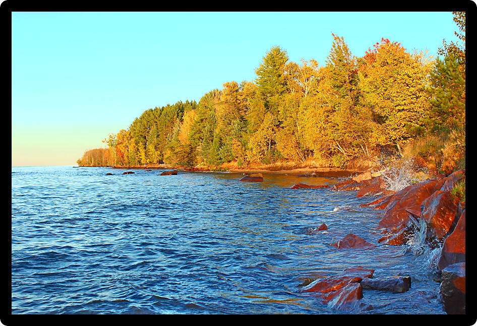 Waves crash along a rocky shoreline of Lake Superior in Ontonagon County Michigan.