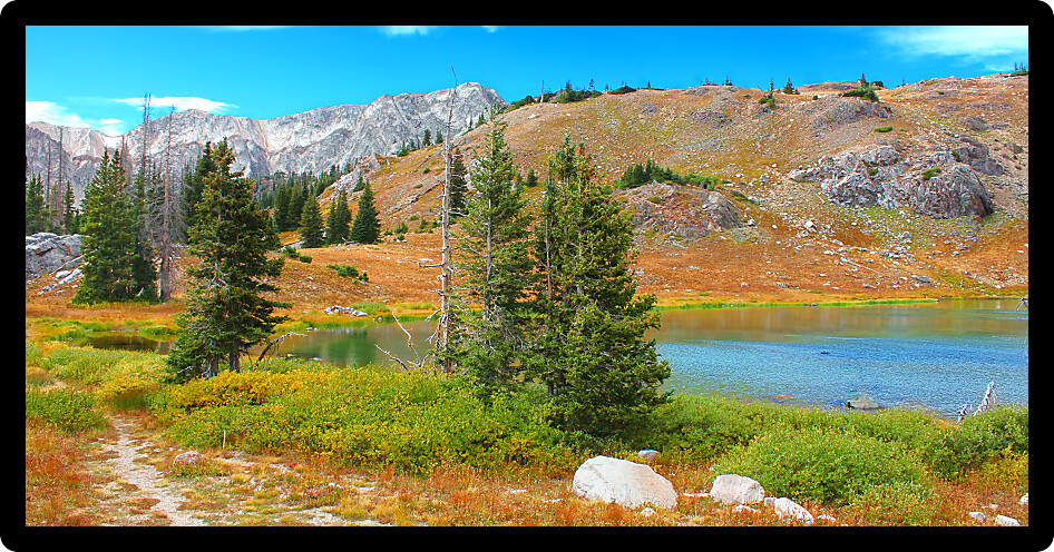 Bellamy Lake below the rugged mountains of the Snowy Range in Medicine Bow National Forest of Wyoming.