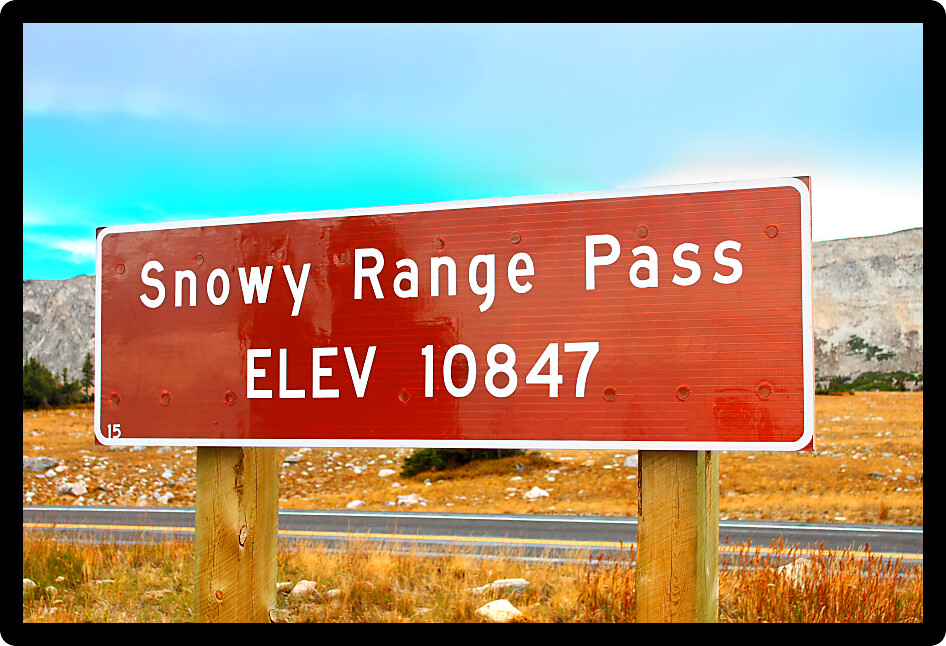Sign highlighting the high altitude of Snowy Range Pass in the Medicine Bow National Forest of Wyoming.