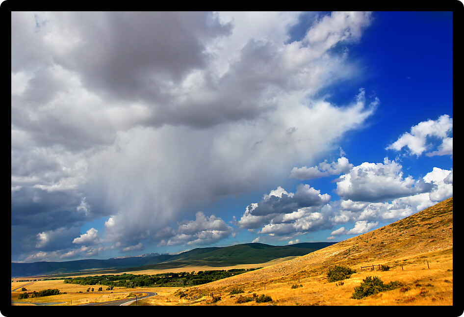 Rolling hills of the Wyoming countryside illuminated under brilliant sunshine.