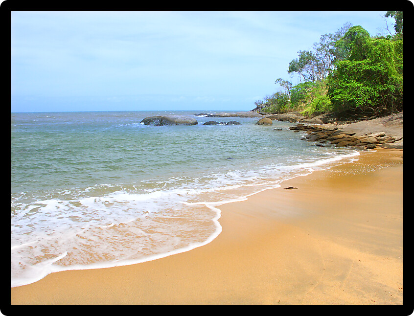 Gentle waves wash ashore at Trinity Beach north of Cairns in Queensland Australia.