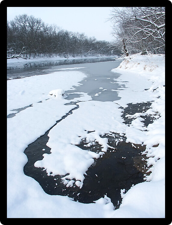 Snowfall along the Kishwaukee River on a cold winter morning at Blackhawk Springs Forest Preserve in northern Illinois.