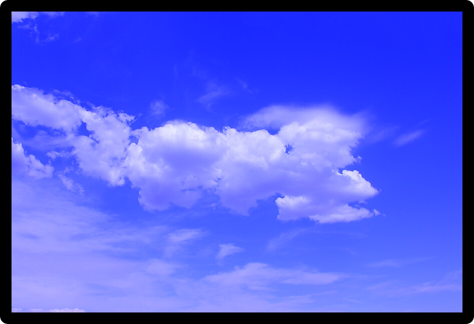 Beautiful blue sky with patchy cloud cover.