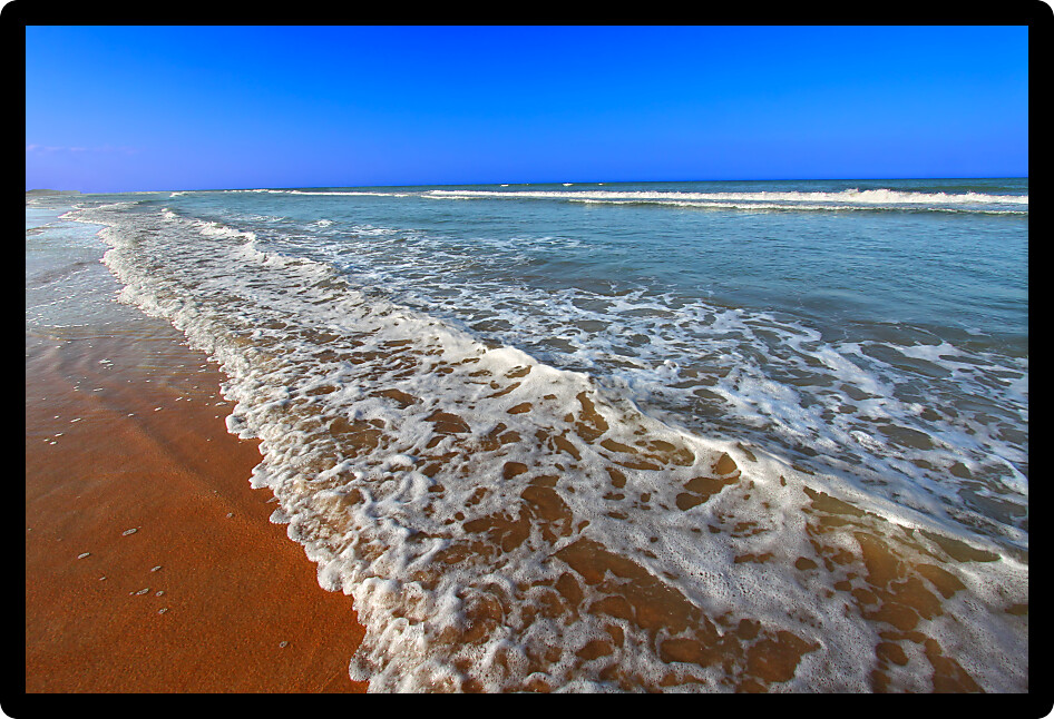 Waves crash along the coast on a beautiful day in Daytona Beach Florida.
