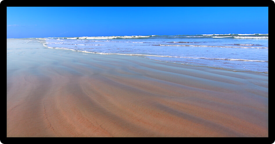 Waves crash along the coast on a beautiful day in Daytona Beach Florida.
