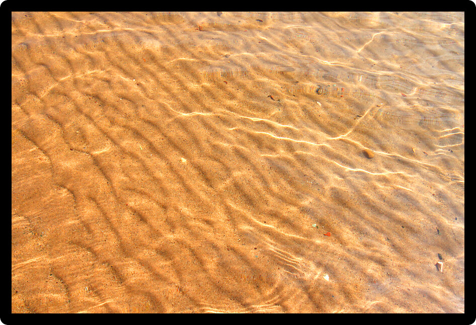 Interesting patterns in the sand seen through crystal clear Wisconsin waters.