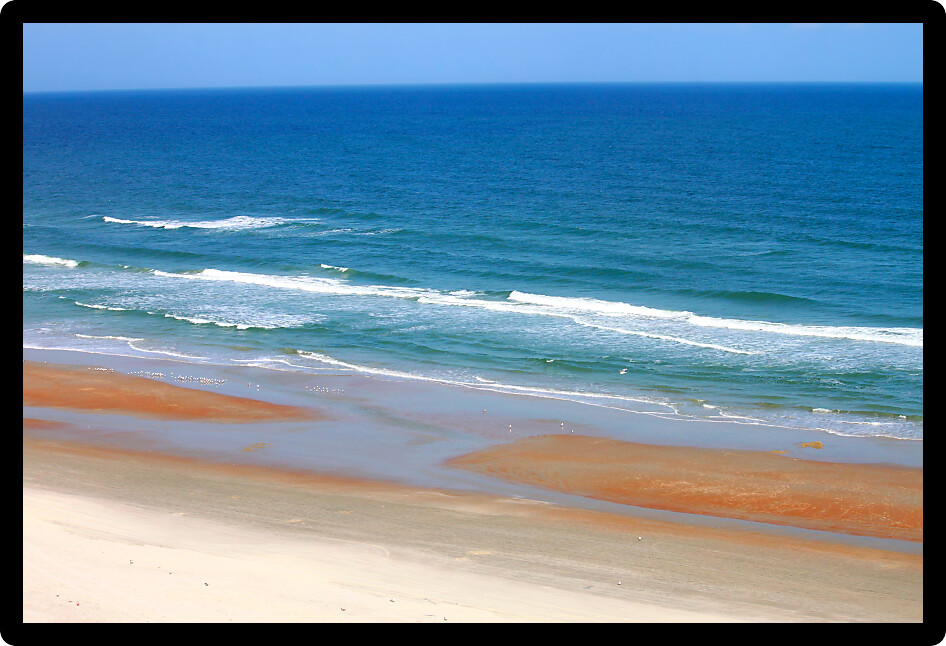 Waves crash along the coast on a beautiful day in Daytona Beach Florida.
