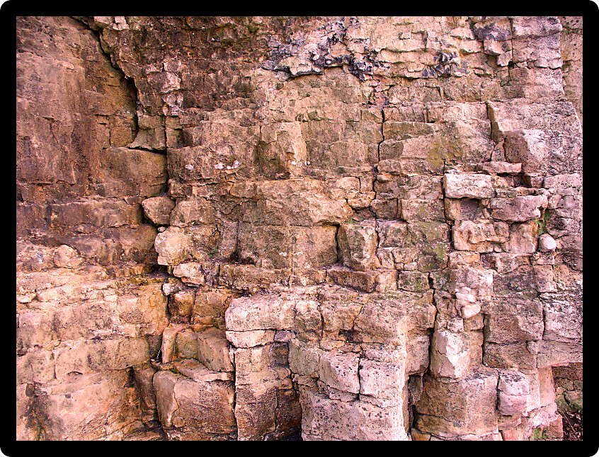 Texture of a hard brown rock wall.