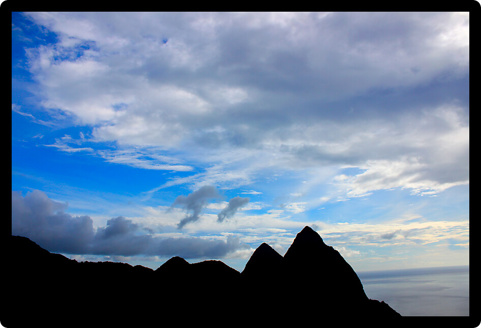 Famous Pitons of Saint Lucia silhouetted against the sky.