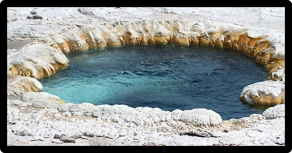 Hot water churns in Beach Spring at the Upper Geyser Basin of Yellowstone National Park.