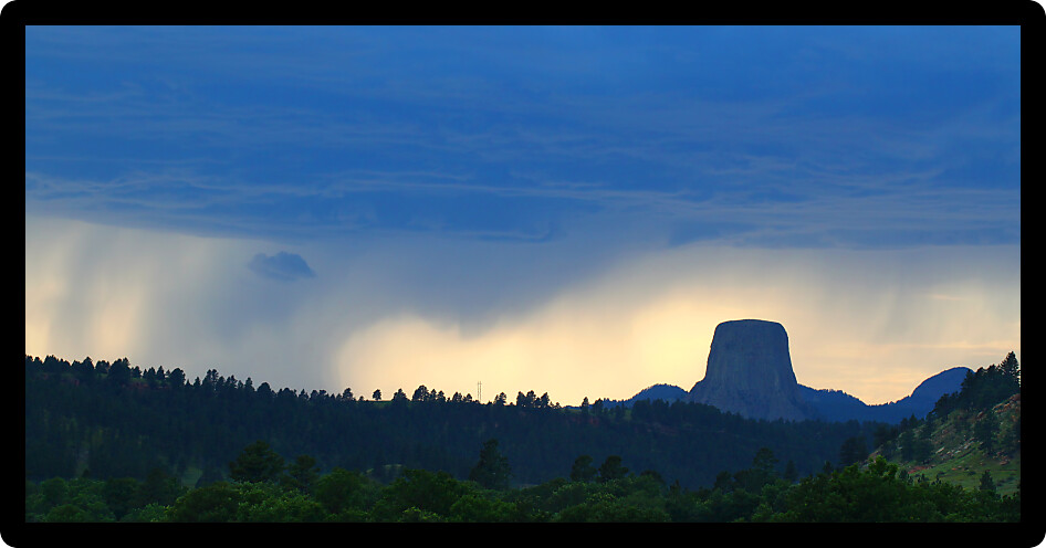Evening rainstorm against sunset over Devils Tower National Monument in northeastern Wyoming.