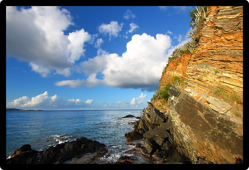 Jagged rock wall rising from the sea on the Caribbean island of Tortola.