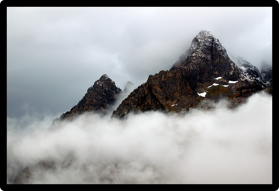 Dense clouds obscure jagged peaks of the Teton Range in western Wyoming
