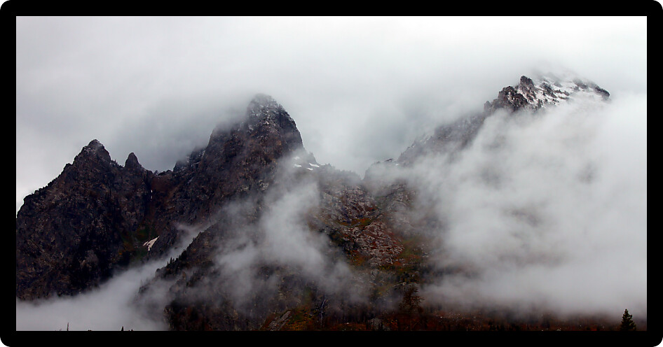 Dense clouds obscure jagged peaks of the Teton Range in western Wyoming