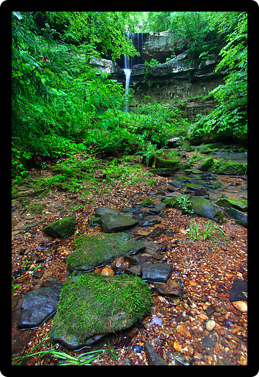 Moss covered boulders below a beautiful waterfall in the deep forests of northern Alabama.