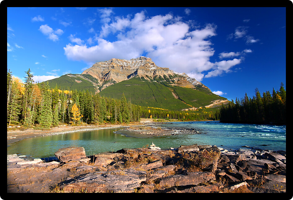 Athabasca River flows through the valley below Mount Kerkeslin of Jasper National Park in Canada.