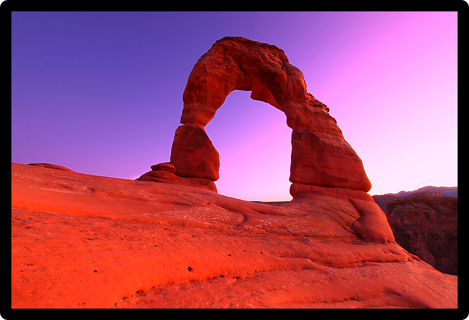 Sunset light behind Delicate Arch in Arches National Park of Utah.
