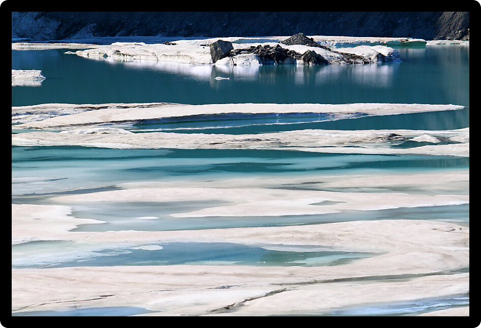 Ice floats amidst a pool of glacial meltwater below the Grinnell Glacier in northern Montana.
