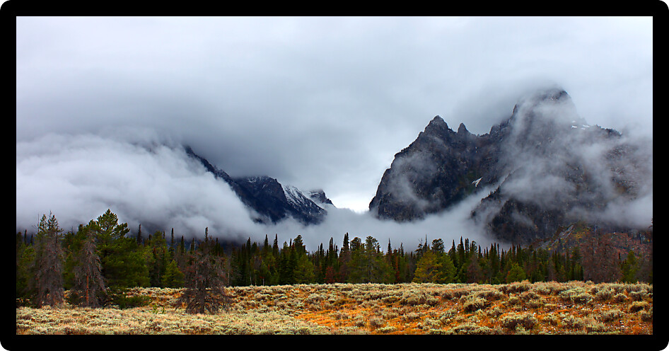 Clouds hang over jagged peaks of the Teton Range in western Wyoming