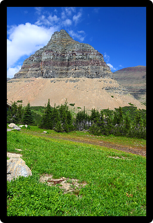 Jagged peaks rise from the ground at Logan Pass of Glacier National Park Montana.