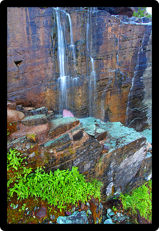 Small waterfall across a trail through the Many Glacier area of Glacier National Park.