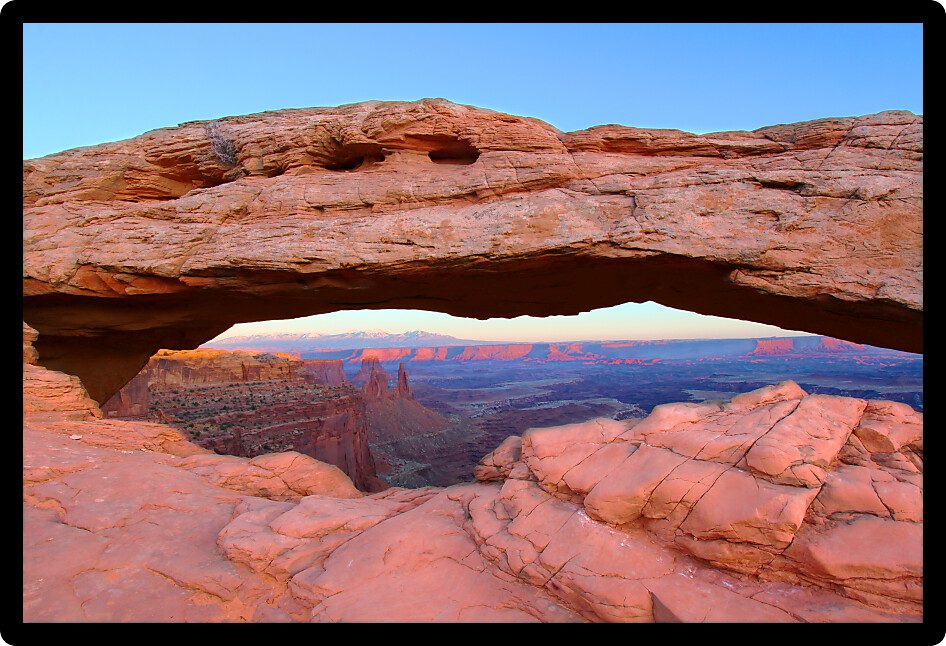 Mesa Arch of Canyonlands National Park under soft evening light.