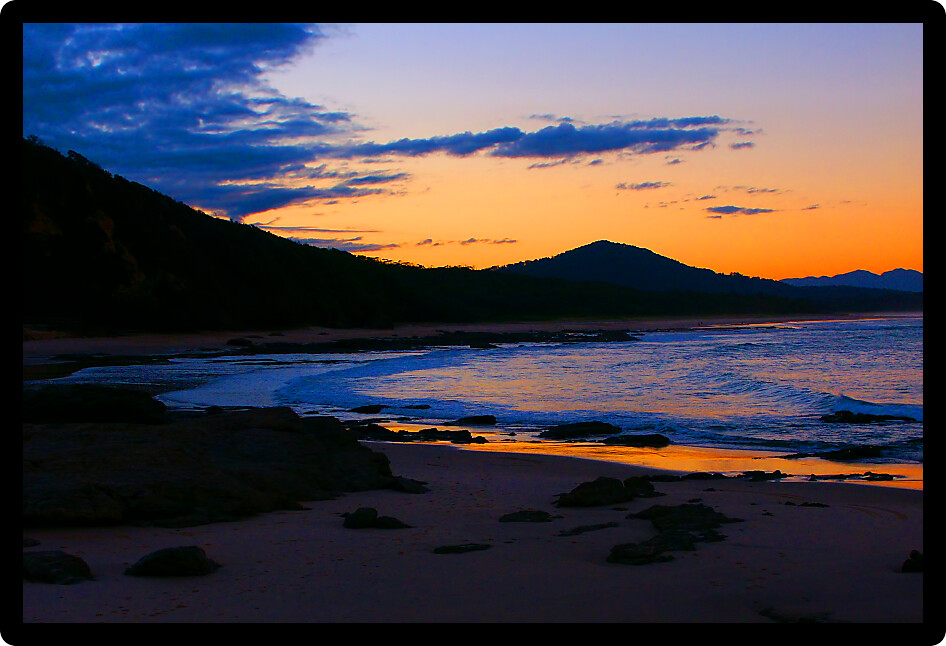 Sunset over evening waves at Nambucca Heads in New South Wales Australia.