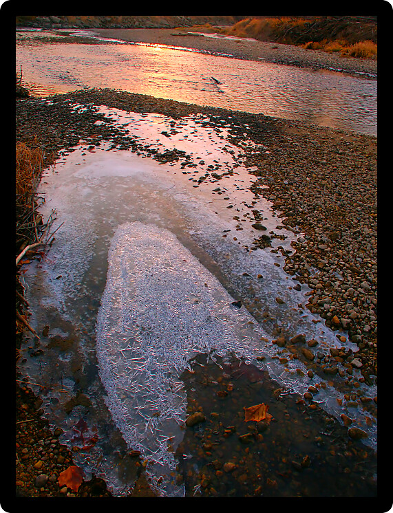 Sunlight gleams off icy waters of the Kishwaukee River in Illinois.