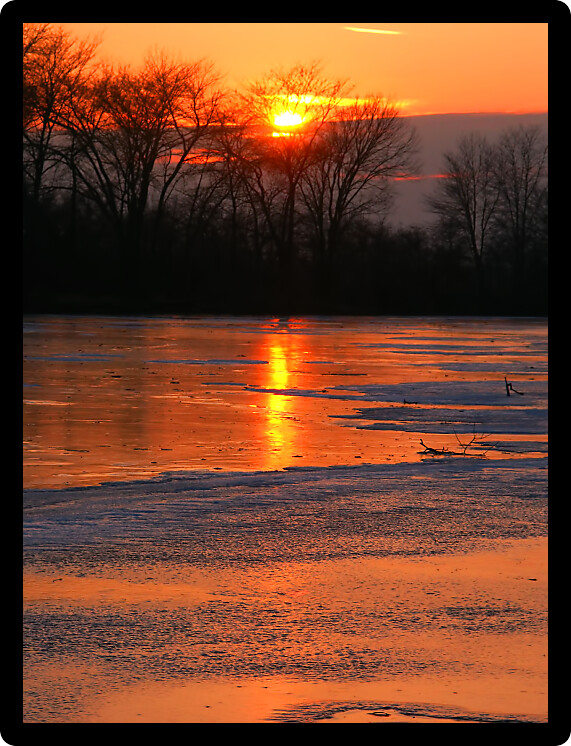 Sunset over frozen backwaters of the Kishwaukee River in northern Illinois.