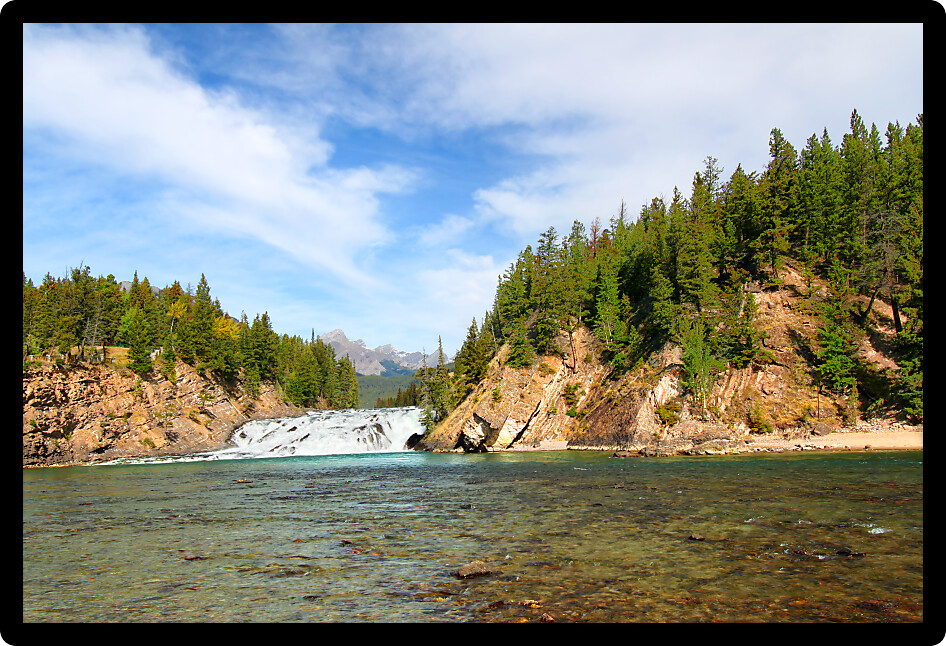 View of Bow Falls flowing through the woodlands of Canada near Banff.
