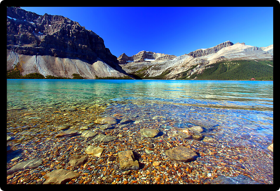 Rocky substrate visible under clear waters of Bow Lake in Banff National Park of Canada.