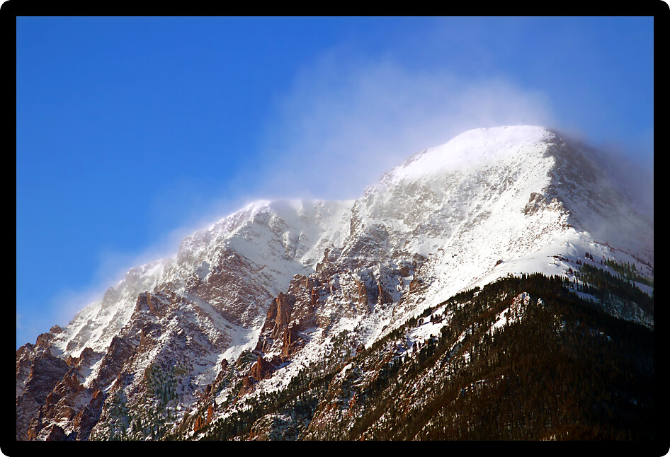 Intense winds create a fog of snow over Mount Chapin of Rocky Mountain National Park in Colorado.