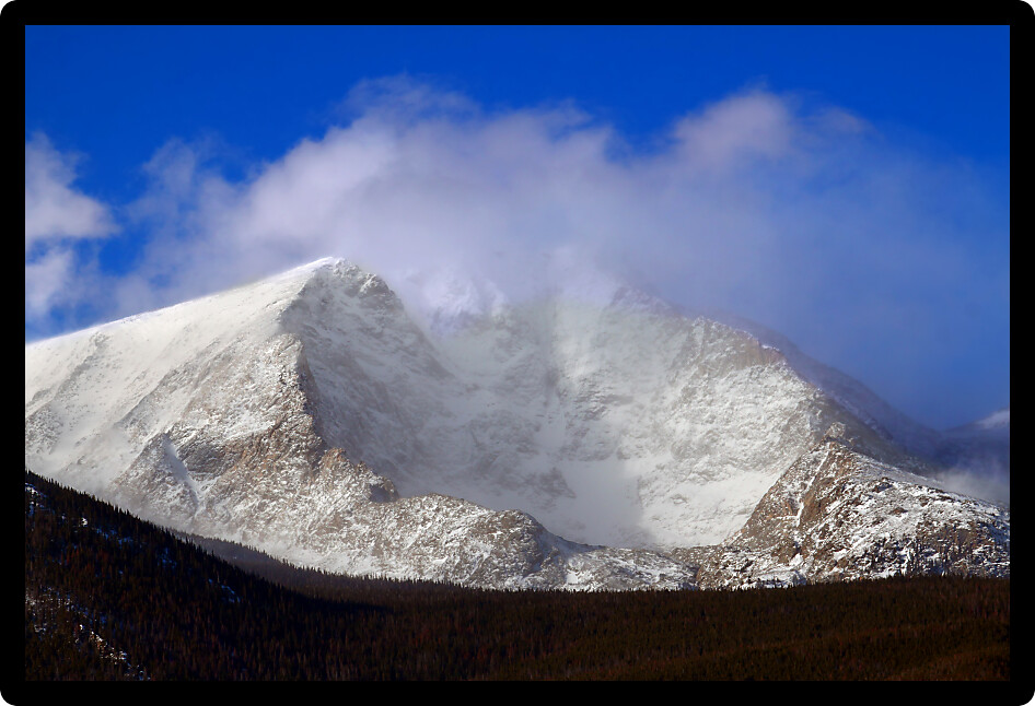 Intense winds create a fog of snow over Mount Ypsilon of Rocky Mountain National Park in Colorado.