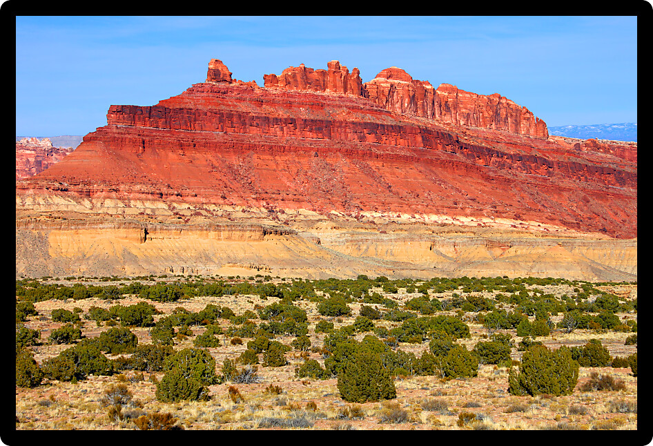 Bright red rock mountains near the Black Dragon Canyon in Utah.